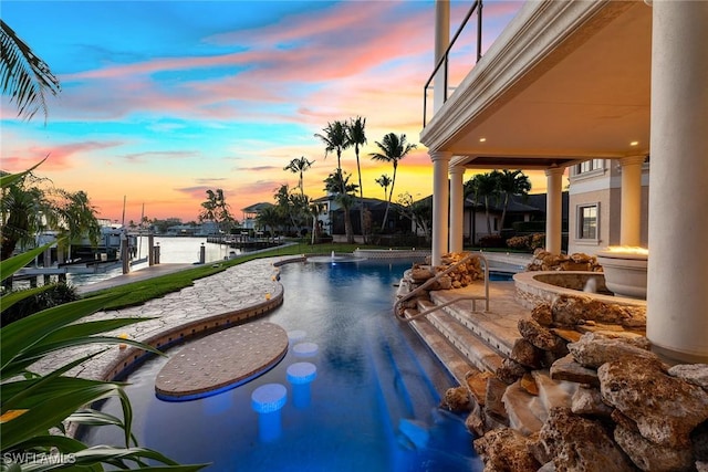 1547 Caxambas Ct, Marco Island, FL 34145 - pool at dusk featuring a water view, a boat dock, an outdoor pool, and boat lift
