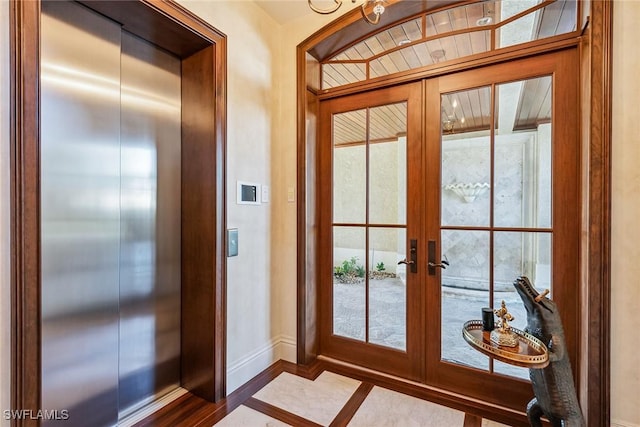 1547 Caxambas Ct, Marco Island, FL 34145 - doorway to outside with elevator, french doors, baseboards, and dark wood-style floors