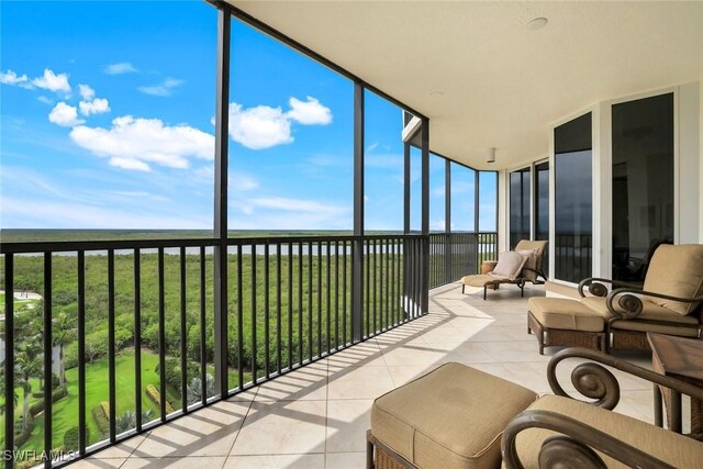 1060 Borghese Ln Unit 1005, Naples, FL 34114 - sunroom with tile patterned floors and expansive windows