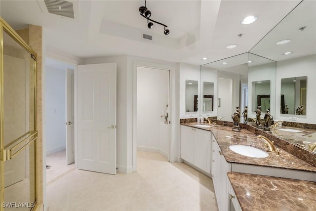 1060 Borghese Ln Unit 1005, Naples, FL 34114 - bathroom with double vanity, recessed lighting, a tray ceiling, an enclosed shower, and baseboards