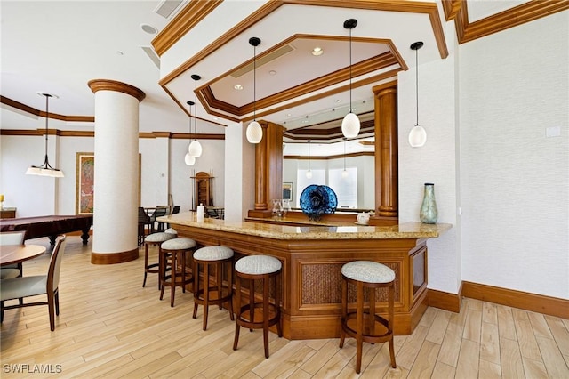 1060 Borghese Ln Unit 1005, Naples, FL 34114 - community bar area with ornate columns, ornamental molding, light wood-style floors, baseboards, and decorative light fixtures