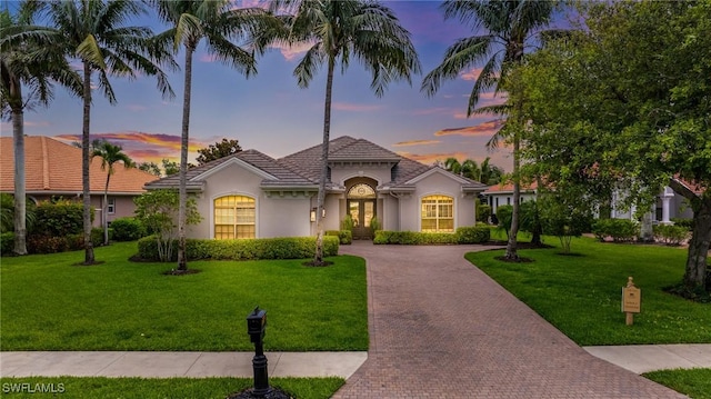 20081 Chapel Trce, Estero, FL 33928 - mediterranean / spanish-style house featuring decorative driveway, stucco siding, and a front yard