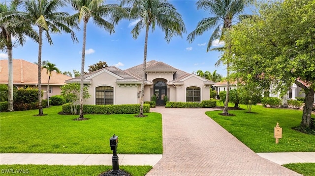 20081 Chapel Trce, Estero, FL 33928 - mediterranean / spanish house with stucco siding, a front lawn, and decorative driveway