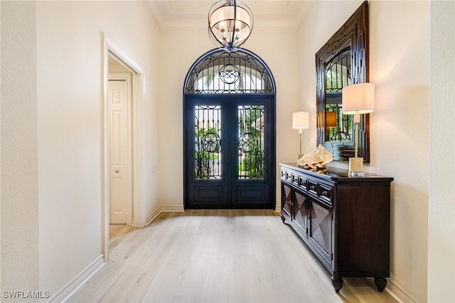 20081 Chapel Trce, Estero, FL 33928 - entryway featuring french doors, wood finished floors, ornamental molding, and a chandelier