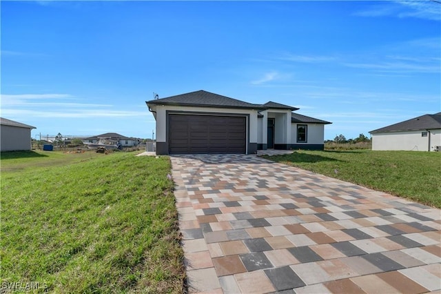 1059 Brenton Ave, Lehigh Acres, FL 33974 - view of front of house featuring decorative driveway, a front lawn, a garage, and stucco siding