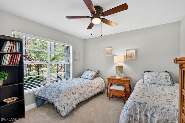 24769 Paradise Rd, Bonita Springs, FL 34135 - bedroom with light colored carpet and a ceiling fan