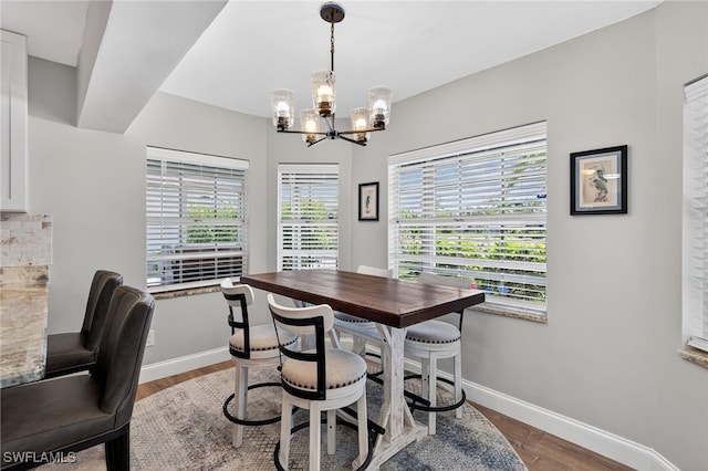 24769 Paradise Rd, Bonita Springs, FL 34135 - dining area featuring a chandelier and wood finished floors