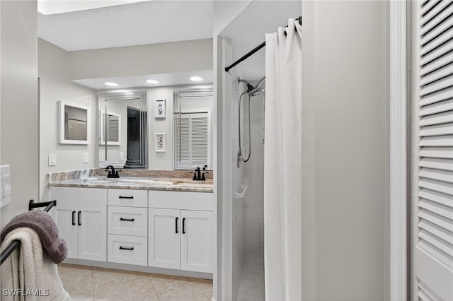 24769 Paradise Rd, Bonita Springs, FL 34135 - bathroom featuring a stall shower, double vanity, tile patterned flooring, and recessed lighting