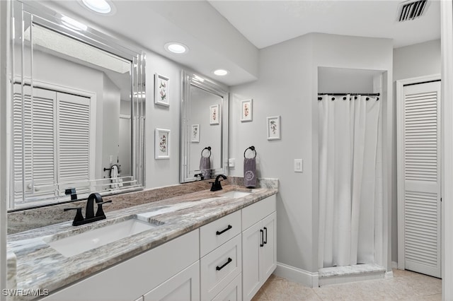 24769 Paradise Rd, Bonita Springs, FL 34135 - bathroom with double vanity, recessed lighting, a shower with shower curtain, a closet, and tile patterned floors