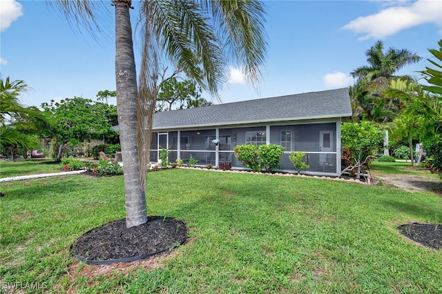 24769 Paradise Rd, Bonita Springs, FL 34135 - ranch-style home with a sunroom, a front lawn, and roof with shingles