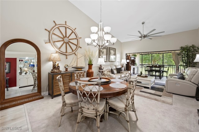 15444 Admiralty Cir Unit 10, North Fort Myers, FL 33917 - dining room featuring high vaulted ceiling, ceiling fan, arched walkways, light carpet, and a chandelier