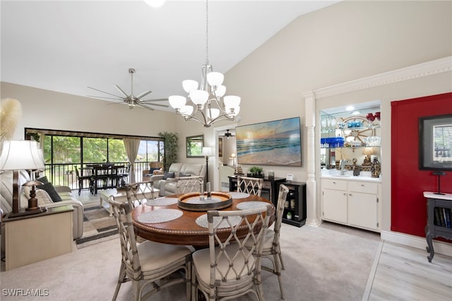 15444 Admiralty Cir Unit 10, North Fort Myers, FL 33917 - dining room with high vaulted ceiling, a ceiling fan, a chandelier, and light wood-style floors