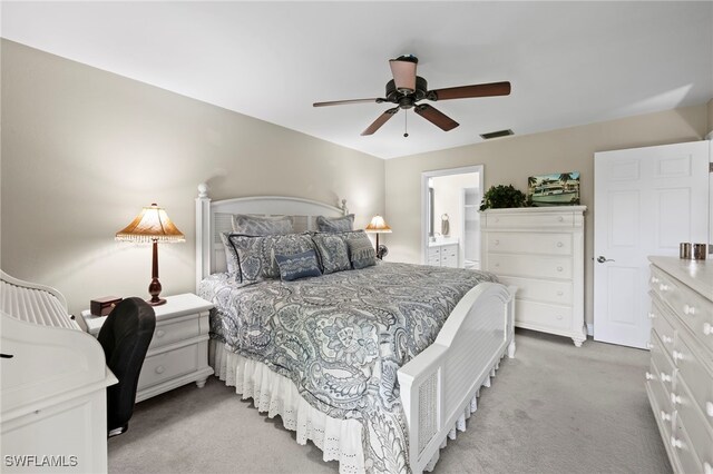 15444 Admiralty Cir Unit 10, North Fort Myers, FL 33917 - bedroom with light colored carpet, connected bathroom, and a ceiling fan