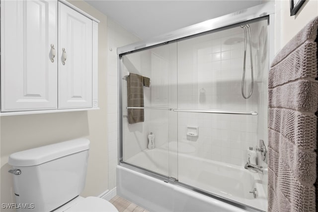 15444 Admiralty Cir Unit 10, North Fort Myers, FL 33917 - bathroom featuring combined bath / shower with glass door, toilet, and baseboards