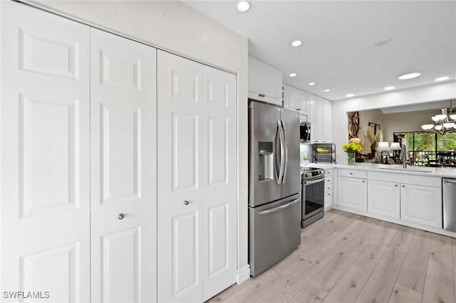 15444 Admiralty Cir Unit 10, North Fort Myers, FL 33917 - kitchen featuring appliances with stainless steel finishes, a sink, light countertops, white cabinetry, and recessed lighting