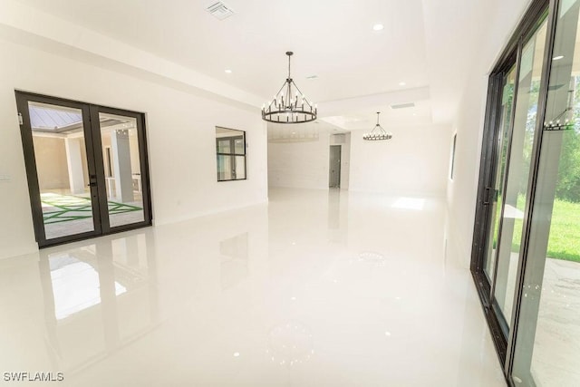 717 Calvin Ave, Lehigh Acres, FL 33972 - hallway with a chandelier, healthy amount of natural light, and recessed lighting
