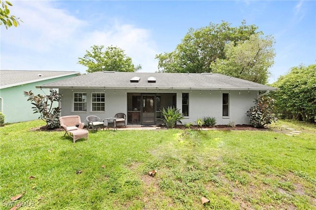 10811 Breaker Ln, Naples, FL 34109 - rear view of house with stucco siding and a yard