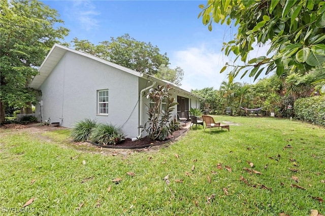10811 Breaker Ln, Naples, FL 34109 - view of home's exterior featuring stucco siding and a lawn