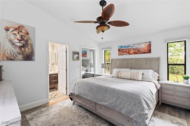 10811 Breaker Ln, Naples, FL 34109 - bedroom with multiple windows, wood finished floors, lofted ceiling, and baseboards
