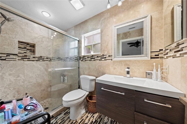 10811 Breaker Ln, Naples, FL 34109 - bathroom featuring tile walls, vanity, a stall shower, and toilet
