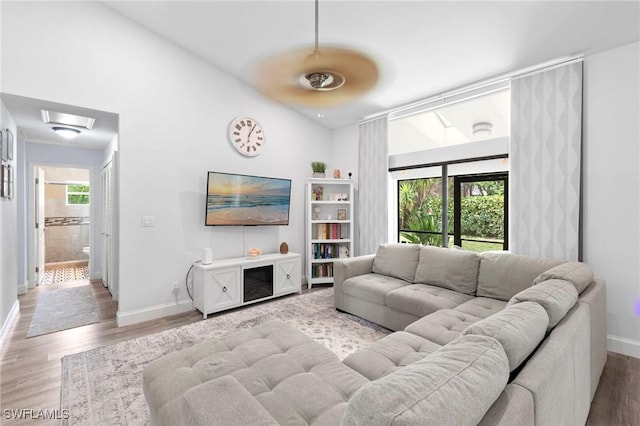 10811 Breaker Ln, Naples, FL 34109 - living room featuring baseboards, light wood-style flooring, and high vaulted ceiling