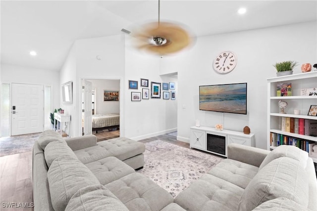 10811 Breaker Ln, Naples, FL 34109 - living room with wood finished floors, recessed lighting, baseboards, and lofted ceiling