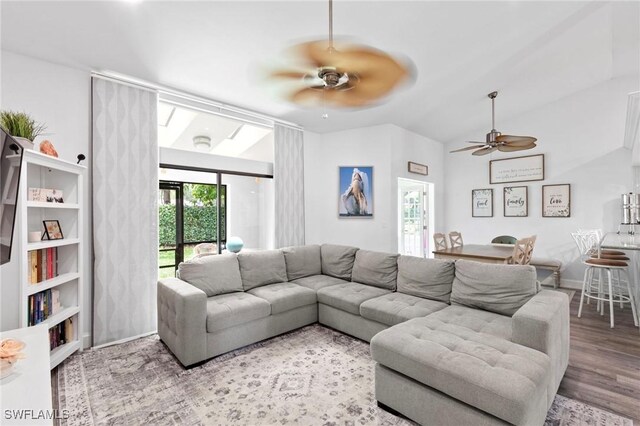 10811 Breaker Ln, Naples, FL 34109 - living room featuring ceiling fan, wood finished floors, baseboards, and vaulted ceiling