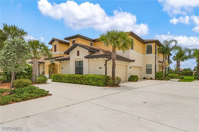 10498 Casella Way Unit 202, Fort Myers, FL 33913 - mediterranean / spanish home featuring driveway, an attached garage, and stucco siding