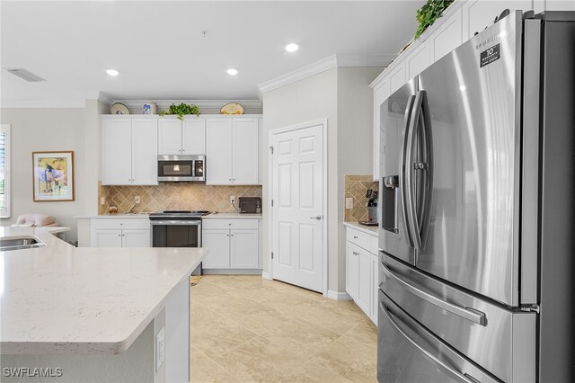 10498 Casella Way Unit 202, Fort Myers, FL 33913 - kitchen featuring stainless steel appliances, crown molding, backsplash, white cabinetry, and recessed lighting
