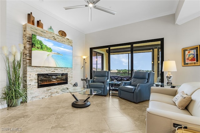 10498 Casella Way Unit 202, Fort Myers, FL 33913 - living area featuring a stone fireplace, ornamental molding, ceiling fan, and tile patterned flooring