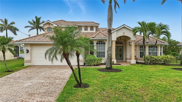 5408 SW 26th Ct, Cape Coral, FL 33914 - mediterranean / spanish home with a tile roof, stucco siding, driveway, and an attached garage