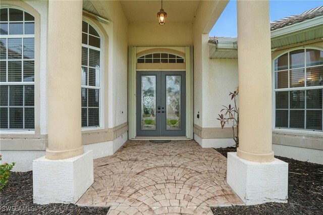 5408 SW 26th Ct, Cape Coral, FL 33914 - view of exterior entry with french doors and stucco siding