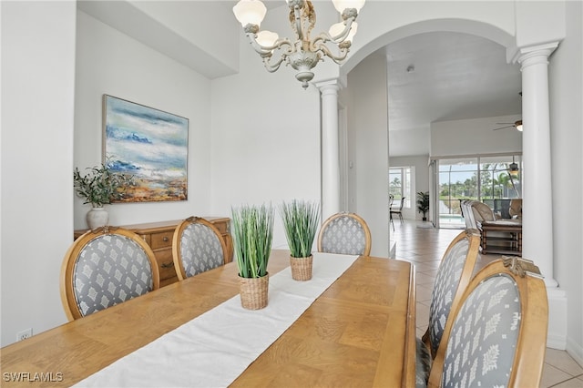 5408 SW 26th Ct, Cape Coral, FL 33914 - dining area featuring ornate columns, tile patterned flooring, arched walkways, a chandelier, and a ceiling fan