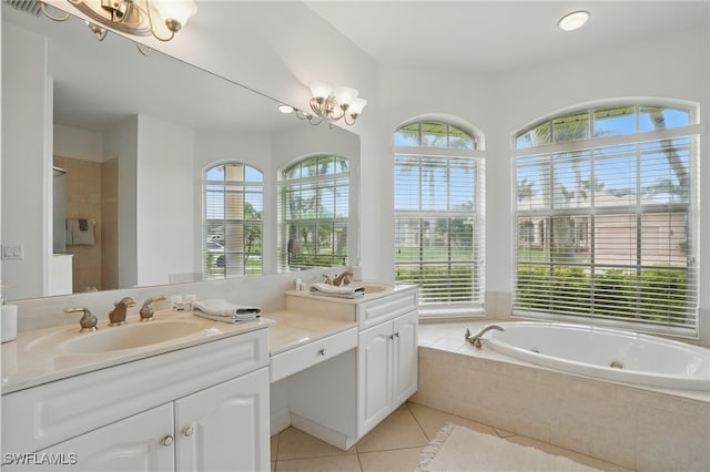 5408 SW 26th Ct, Cape Coral, FL 33914 - full bathroom with healthy amount of natural light, double vanity, a jetted tub, and tile patterned floors