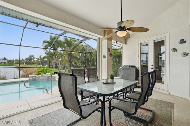 5408 SW 26th Ct, Cape Coral, FL 33914 - view of patio / terrace featuring a ceiling fan, an outdoor pool, outdoor dining area, a lanai, and a water view