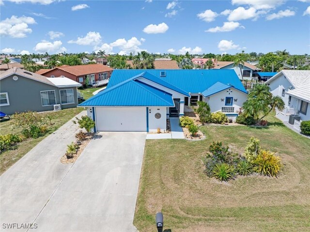 3825 Barnegat Dr, Punta Gorda, FL 33950 - ranch-style house featuring a residential view, metal roof, driveway, a garage, and a front yard