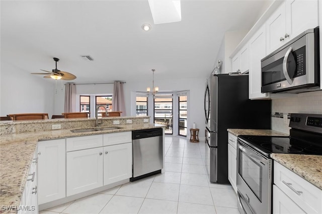 3825 Barnegat Dr, Punta Gorda, FL 33950 - kitchen with stainless steel appliances, a sink, decorative backsplash, white cabinets, and recessed lighting