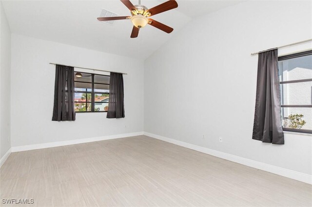 3825 Barnegat Dr, Punta Gorda, FL 33950 - empty room featuring lofted ceiling, plenty of natural light, a ceiling fan, and baseboards