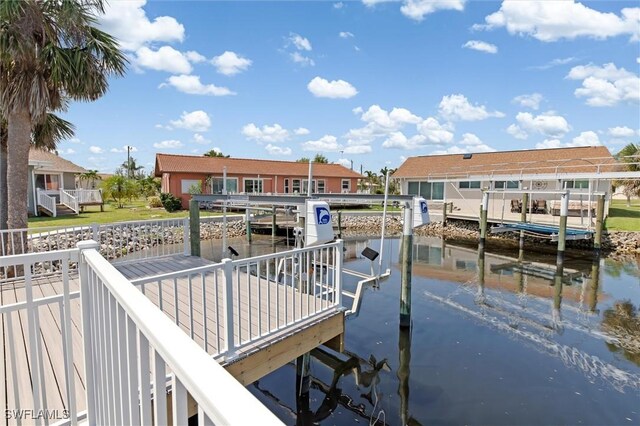 3825 Barnegat Dr, Punta Gorda, FL 33950 - dock area with boat lift, a water view, and a residential view