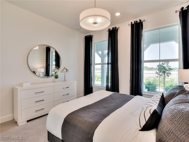 17304 Green Buttonwood Way N, Fort Myers, FL 33917 - bedroom with light colored carpet, multiple windows, baseboards, and recessed lighting