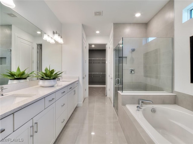 17304 Green Buttonwood Way N, Fort Myers, FL 33917 - bathroom with a stall shower, double vanity, a bath, a walk in closet, and tile patterned flooring