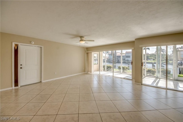 4013 SE 19th Pl Unit 101, Cape Coral, FL 33904 - empty room featuring baseboards, ceiling fan, and light tile patterned floors