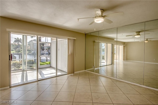 4013 SE 19th Pl Unit 101, Cape Coral, FL 33904 - tiled empty room featuring baseboards, ceiling fan, and a water view