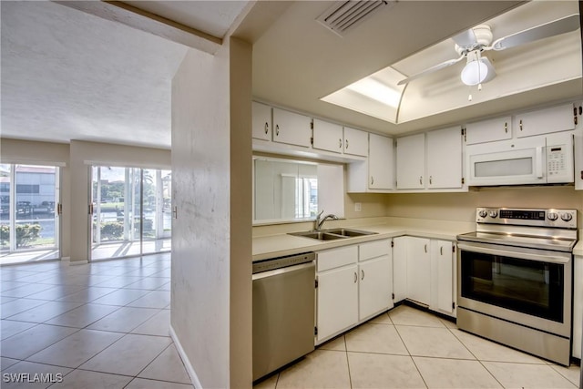 4013 SE 19th Pl Unit 101, Cape Coral, FL 33904 - kitchen featuring stainless steel appliances, a sink, plenty of natural light, and light tile patterned flooring