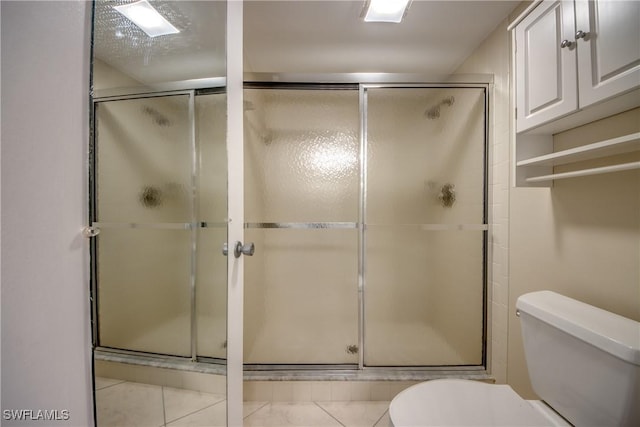 4013 SE 19th Pl Unit 101, Cape Coral, FL 33904 - bathroom featuring toilet, a stall shower, and tile patterned flooring