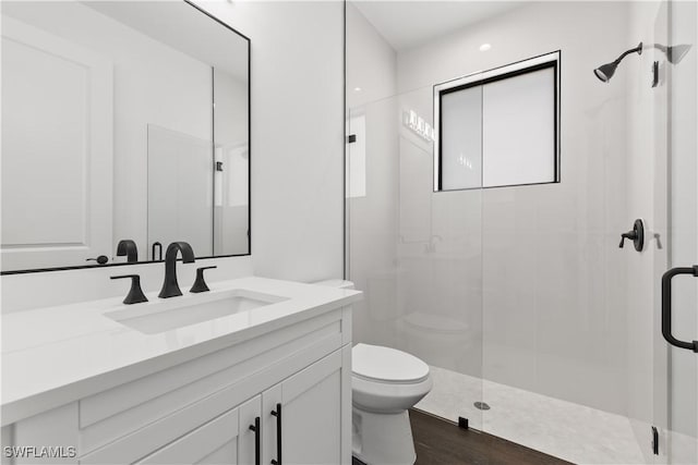 3473 14th Ave SE, Naples, FL 34117 - full bathroom featuring vanity, a stall shower, and wood finished floors