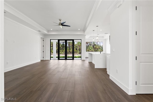 3473 14th Ave SE, Naples, FL 34117 - unfurnished living room featuring a raised ceiling, a ceiling fan, dark wood-style floors, recessed lighting, and ornamental molding
