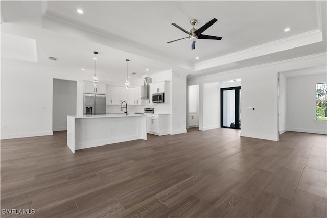 3473 14th Ave SE, Naples, FL 34117 - unfurnished living room featuring a raised ceiling, a ceiling fan, recessed lighting, crown molding, and dark wood-style flooring