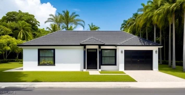763 Milano Ave S, Lehigh Acres, FL 33974 - view of front facade with a garage, stucco siding, and a front yard