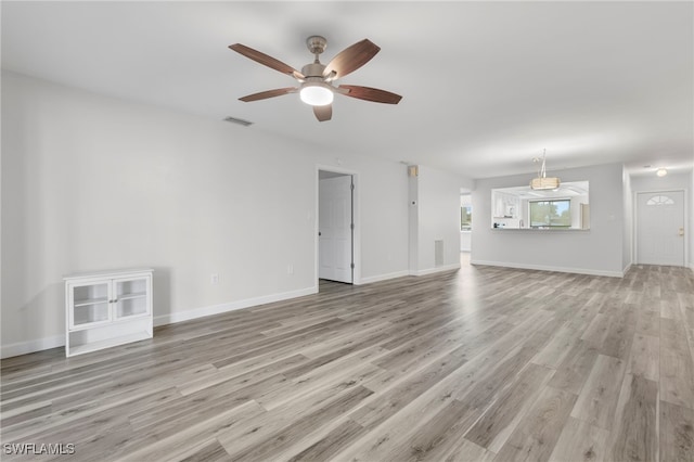4717 Santa Barbara Blvd Unit G-2, Cape Coral, FL 33914 - unfurnished living room featuring a ceiling fan, light wood-style flooring, and baseboards